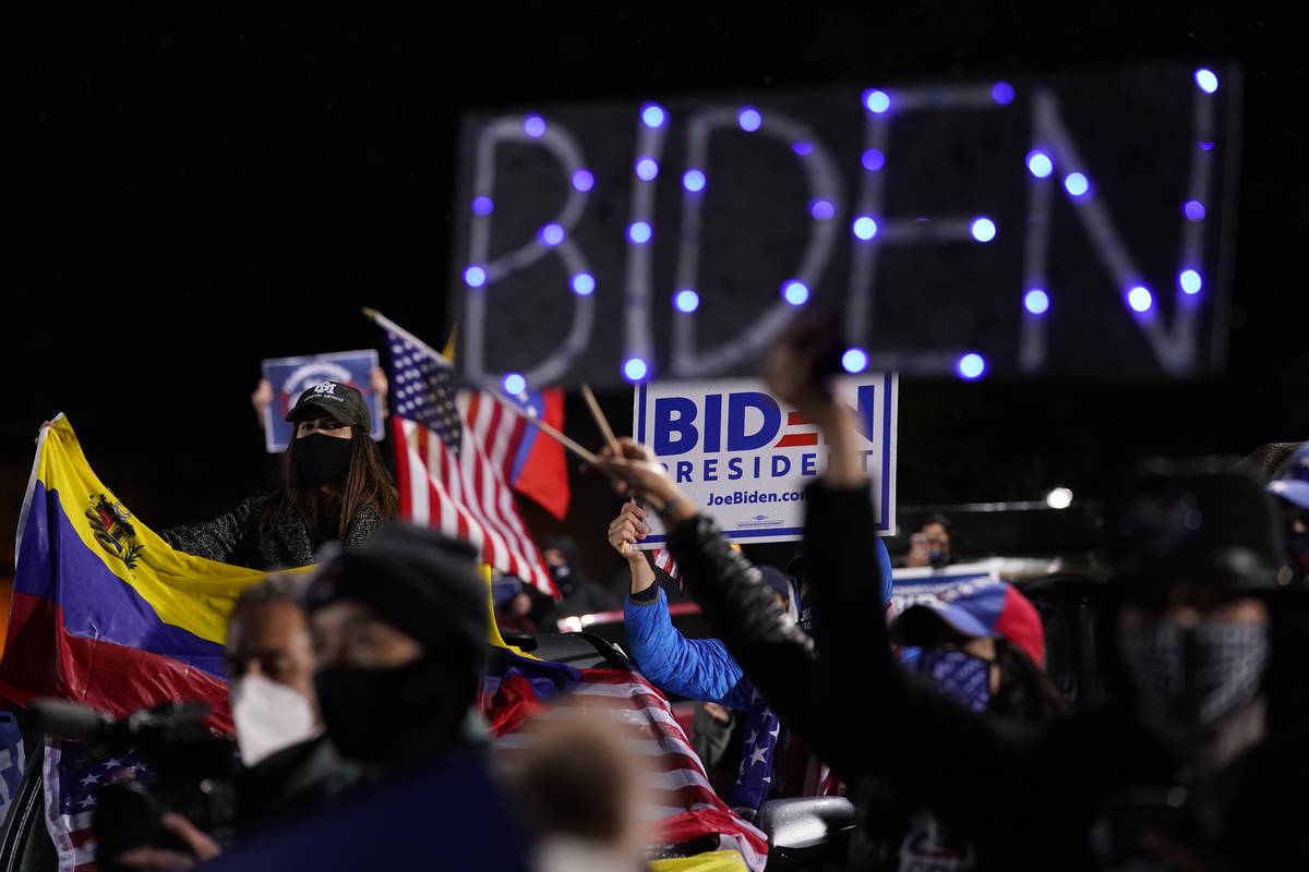 Biden supporters listen as Democratic presidential candidate former Vice President Joe Biden sp ...