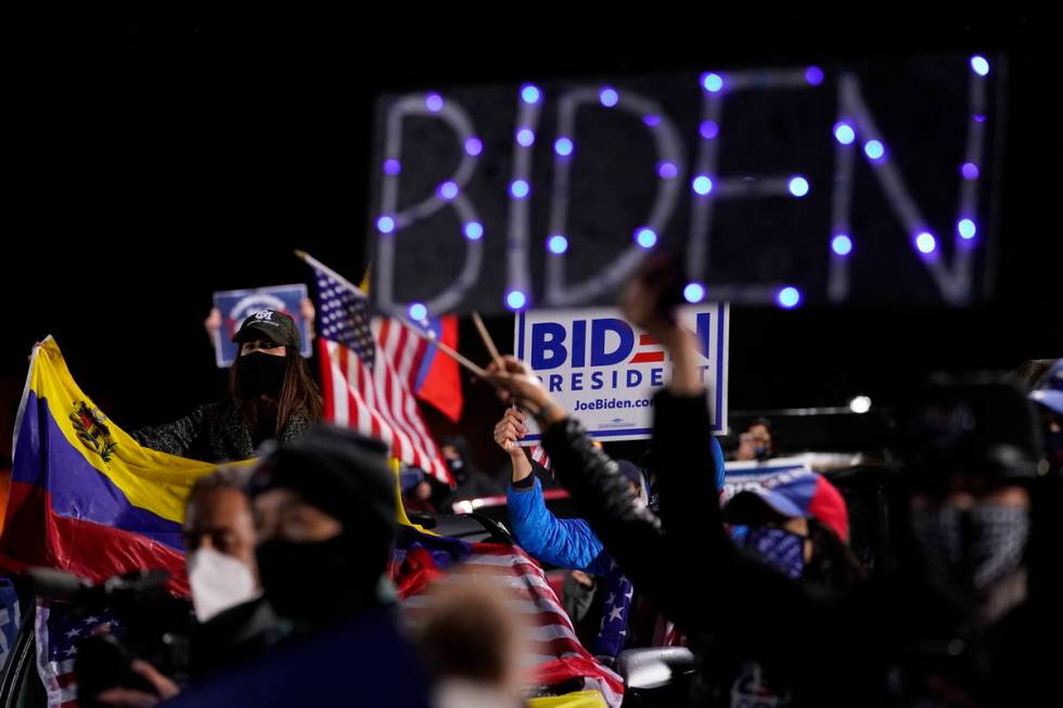 Biden supporters listen as Democratic presidential candidate former Vice President Joe Biden sp ...