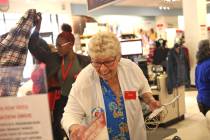 Seasonal worker Debrah Williams laughs as she works at the J.C. Penney at the Galleria at Sunse ...