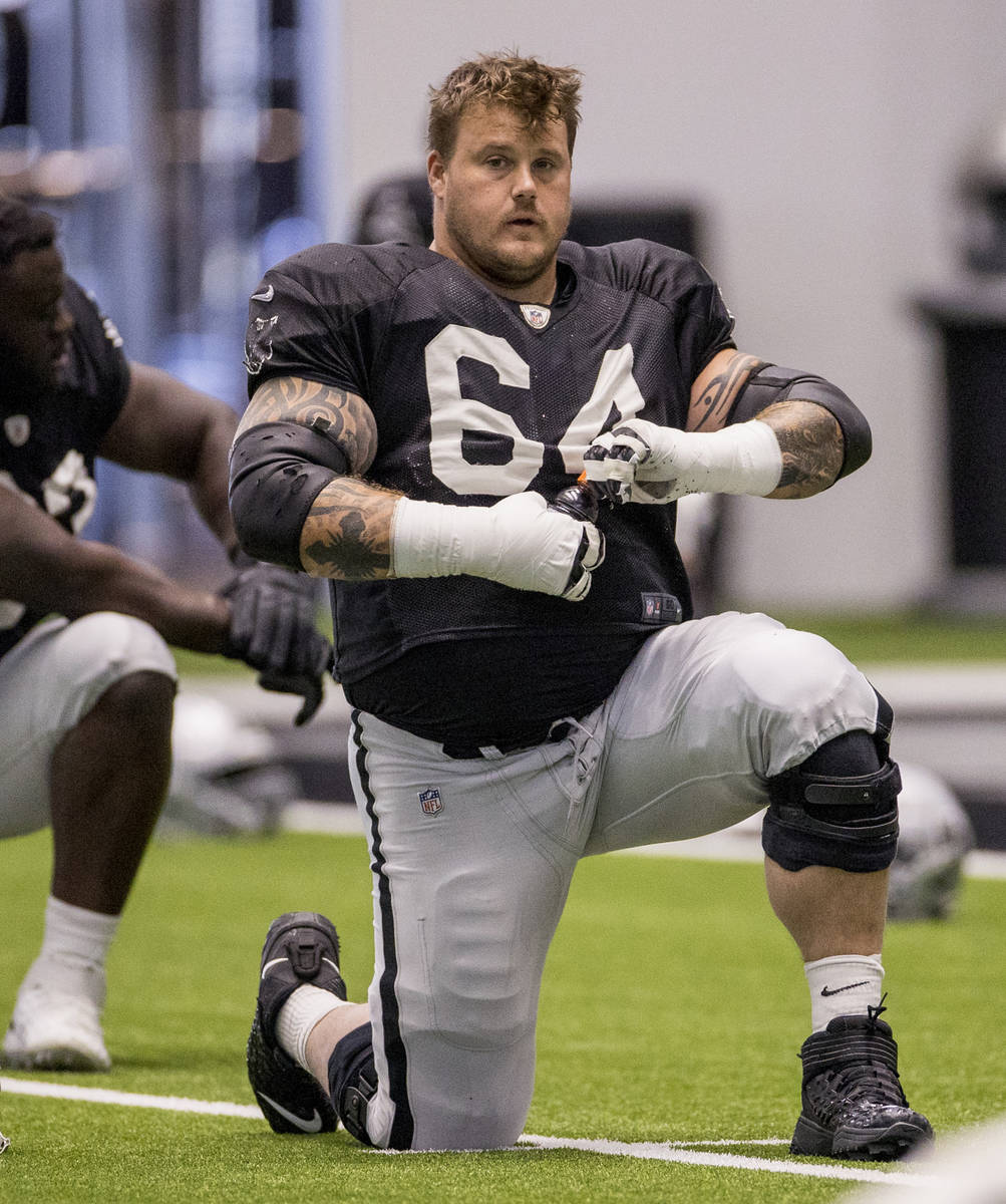 Las Vegas Raiders guard Richie Incognito (64) stretches with teammates during warm ups at the I ...