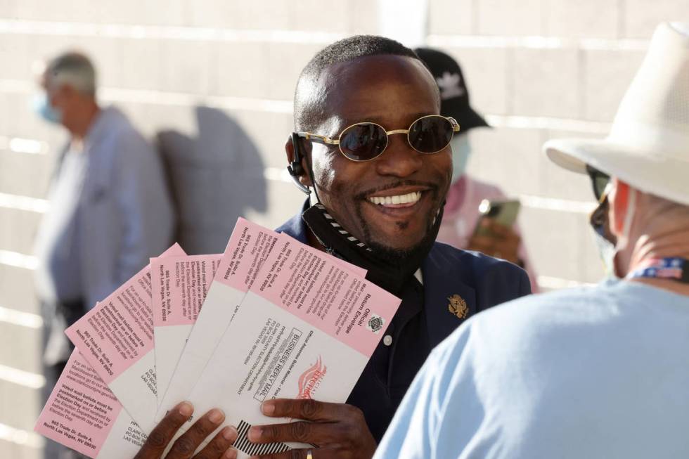 Mack Miller, a Republican candidate for Assembly District 5, shows mail-in ballots he is droppi ...