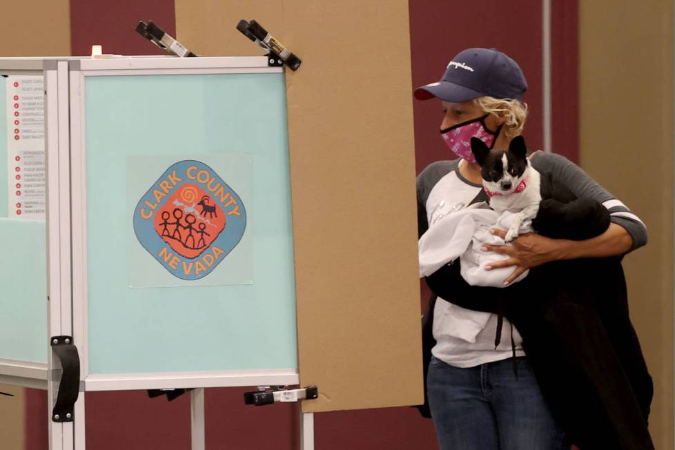 Marcy Vejar and her dog Miss Sloan vote at Desert Breeze Community Center in Las Vegas on Elect ...