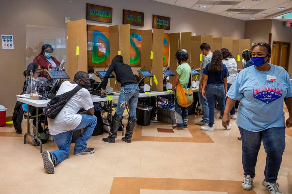 Voters begin the check-in process at the Doolittle Community Center voter center during Electio ...