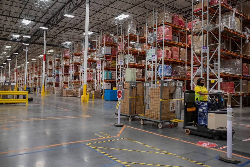 A worker is seen at an Amazon warehouse in North Las Vegas on Thursday, July 30, 2020. (Elizabe ...