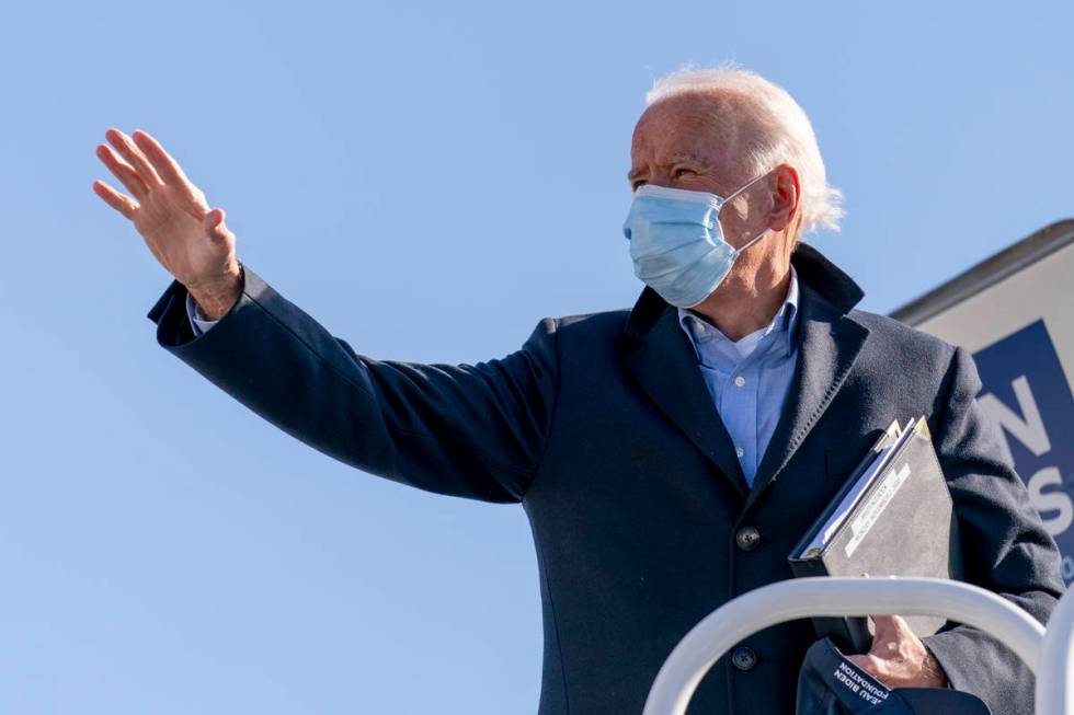 Democratic presidential candidate former Vice President Joe Biden boards his campaign plane in ...