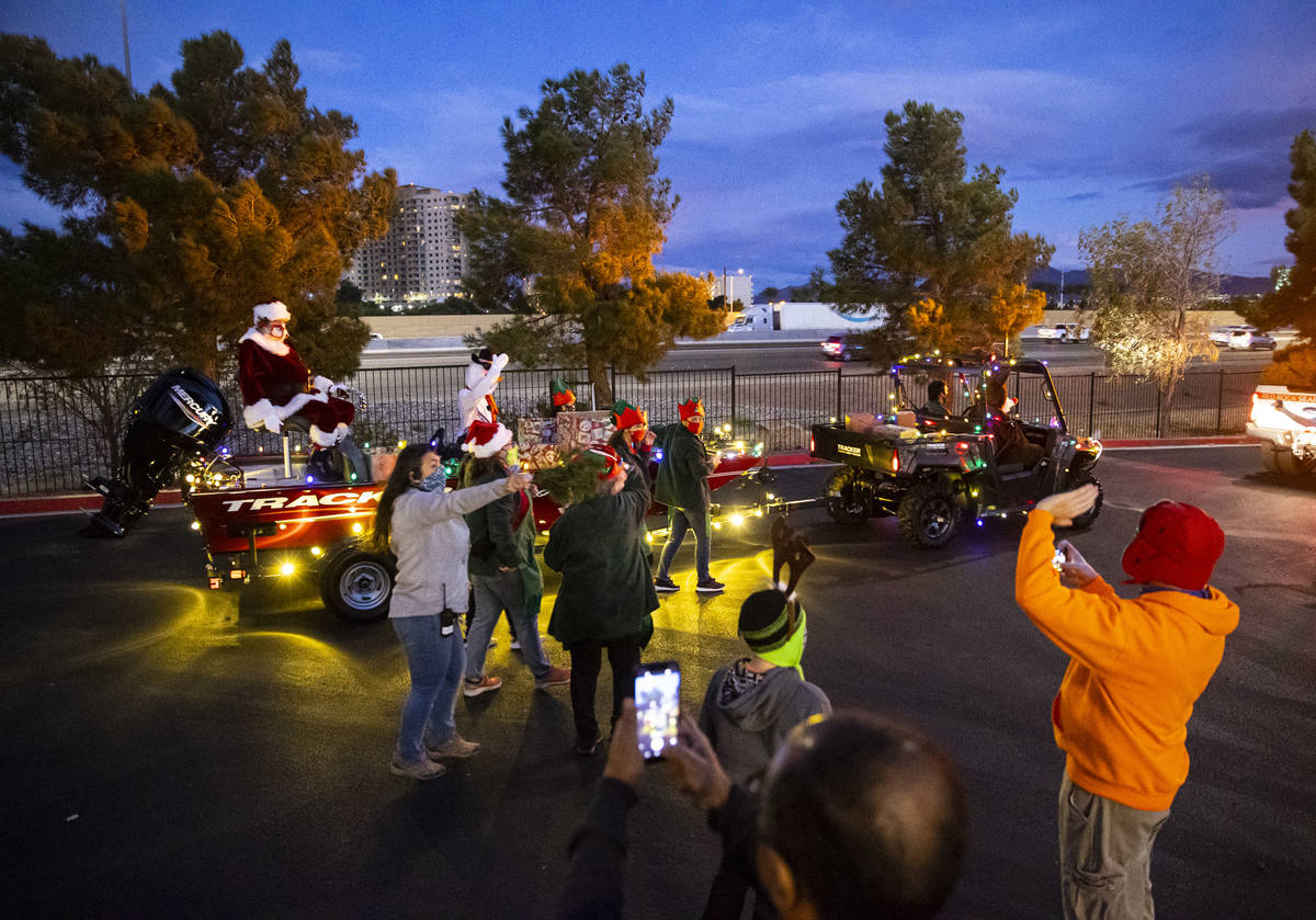 Santa Claus waves to people during a parade at Bass Pro Shops in Las Vegas on Saturday, Nov. 7, ...