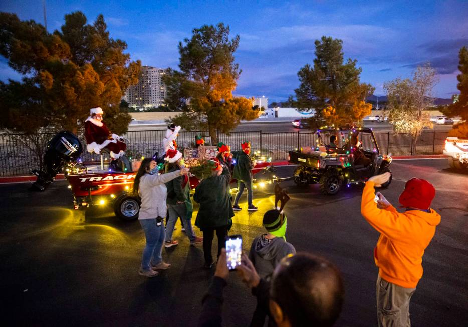 Santa Claus waves to people during a parade at Bass Pro Shops in Las Vegas on Saturday, Nov. 7, ...