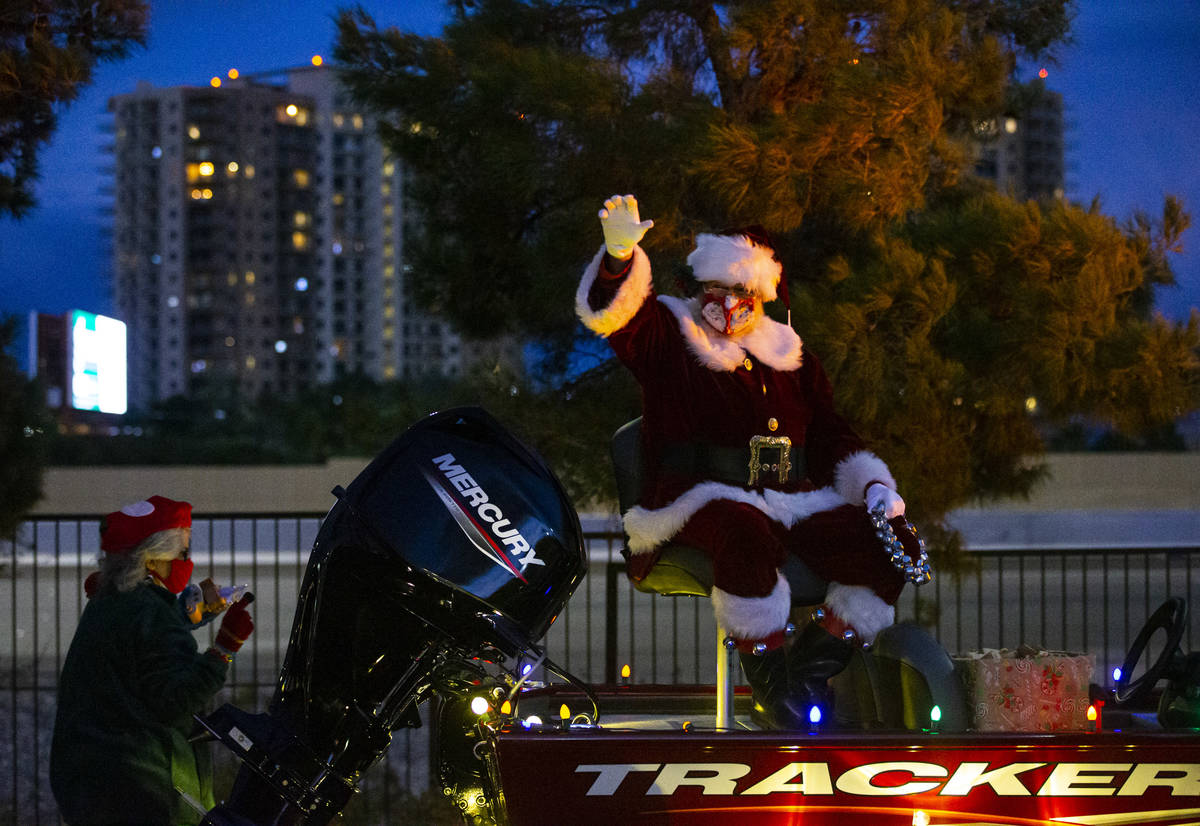 Santa Claus waves to people during a parade at Bass Pro Shops in Las Vegas on Saturday, Nov. 7, ...