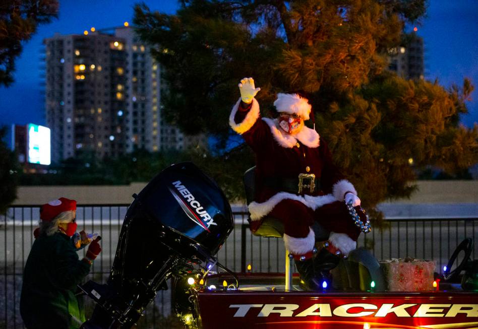 Santa Claus waves to people during a parade at Bass Pro Shops in Las Vegas on Saturday, Nov. 7, ...