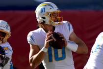 Los Angeles Chargers quarterback Justin Herbert (10) looks to throw during the first half of an ...