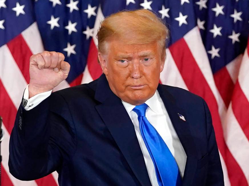 President Donald Trump pumps his fist after speaking in the East Room of the White House, early ...