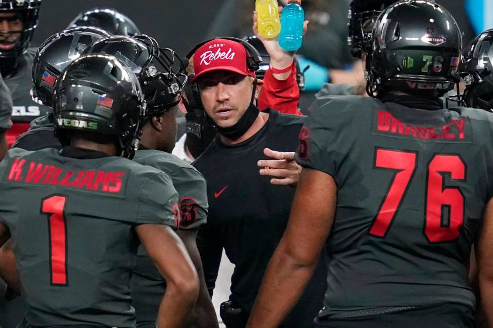 UNLV head coach Marcus Arroyo speaks with his players during the second half of an NCAA college ...