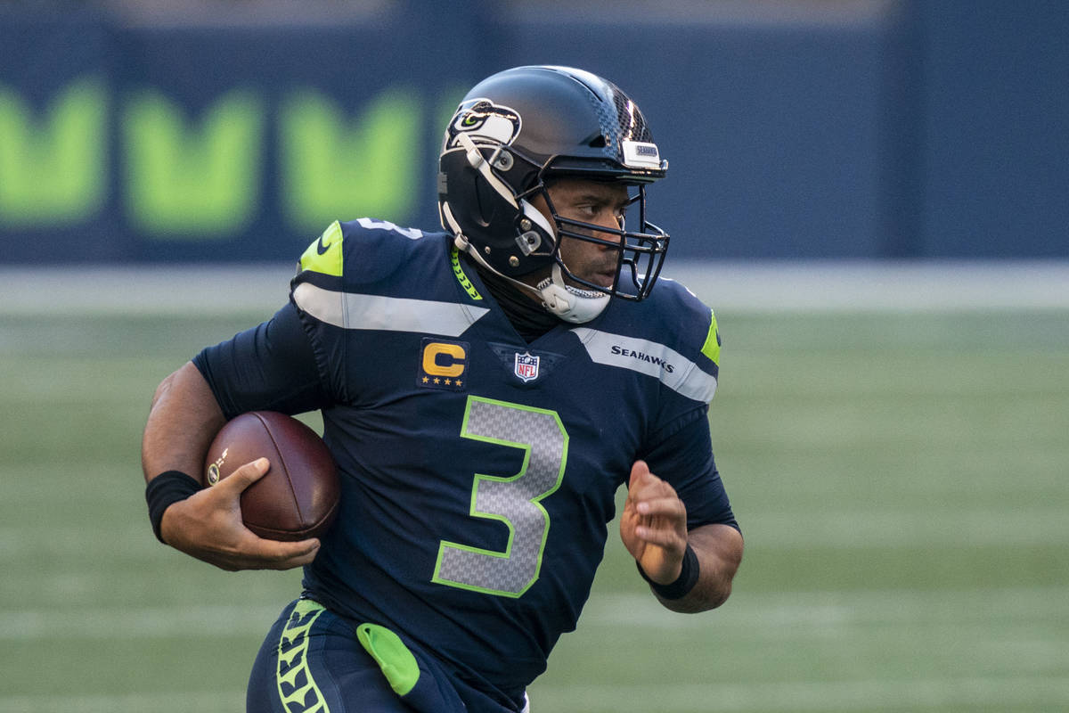 Seattle Seahawks quarterback Russell Wilson scrambles out of the pocket during the second half ...