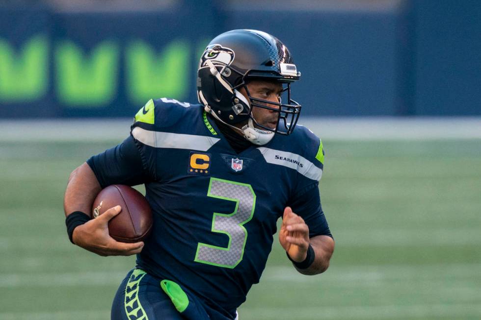 Seattle Seahawks quarterback Russell Wilson scrambles out of the pocket during the second half ...