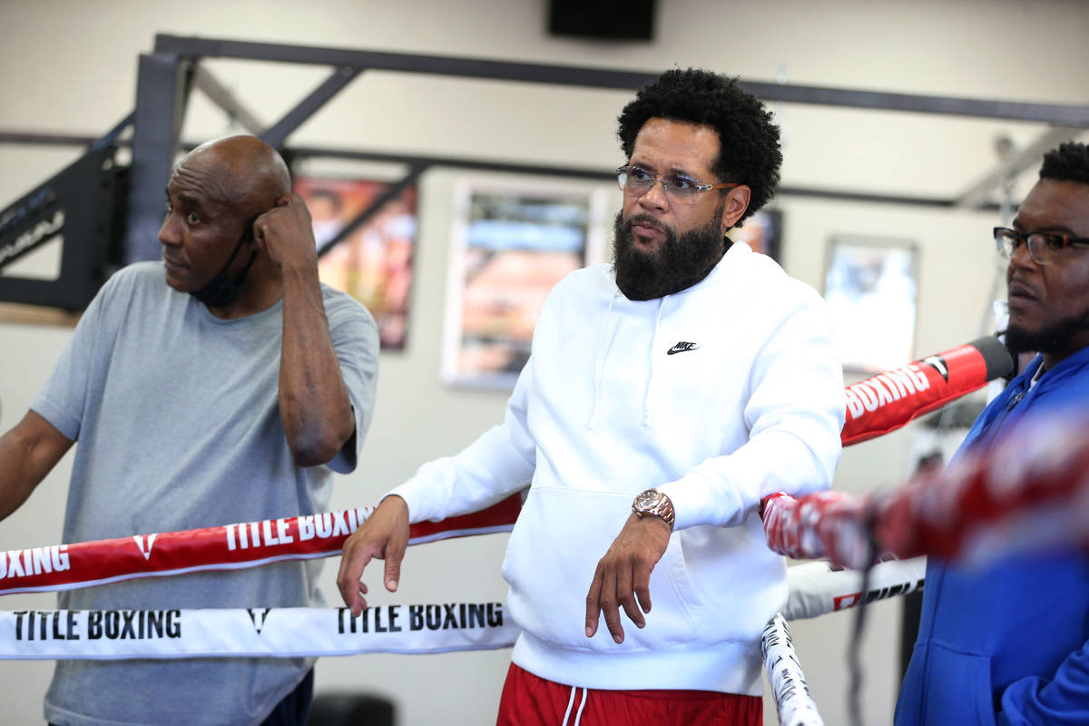 Boxing trainer William "Bill" Haney, center, watches his son Devin Haney hit the mitt ...