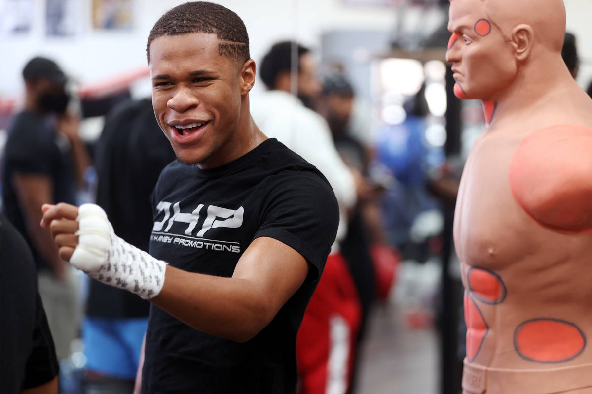 Boxer Devin Haney interacts with people during a boxing gym workout at Title Boxing gym in Las ...
