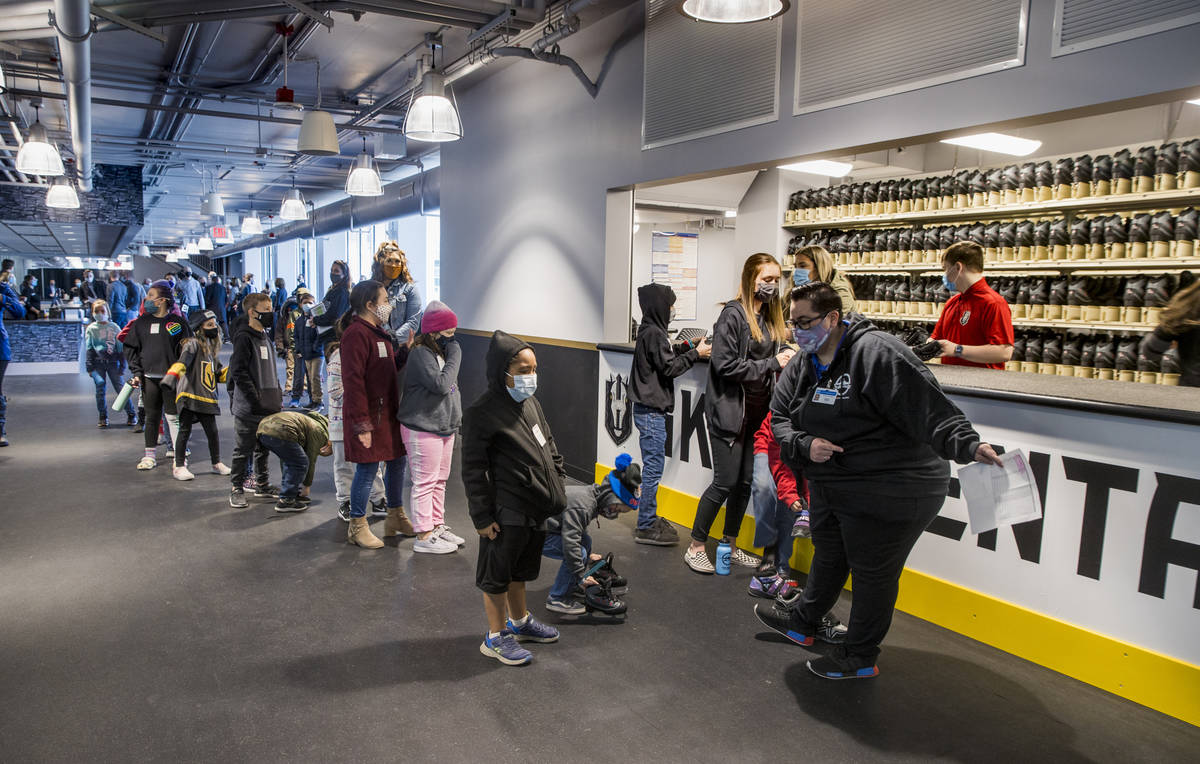 Young fans with the Battle Born Kids Program line up to receive skates for the opening day at t ...