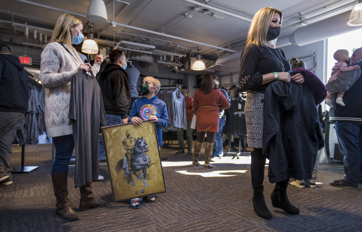 Rachel Roberts, left, with son Justin, 8, wait in line to purchase items at The Livery team sto ...