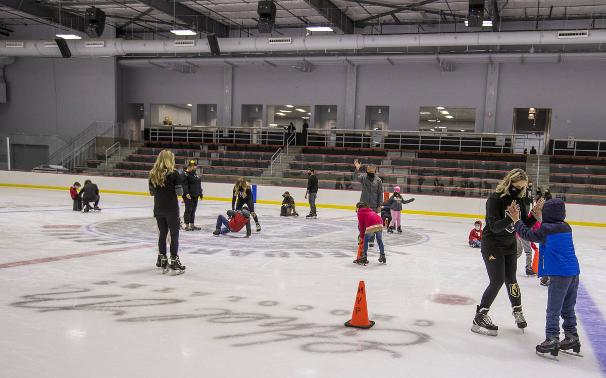Knights Guard members assist youngsters with the Battle Born Kids Program during opening day sk ...