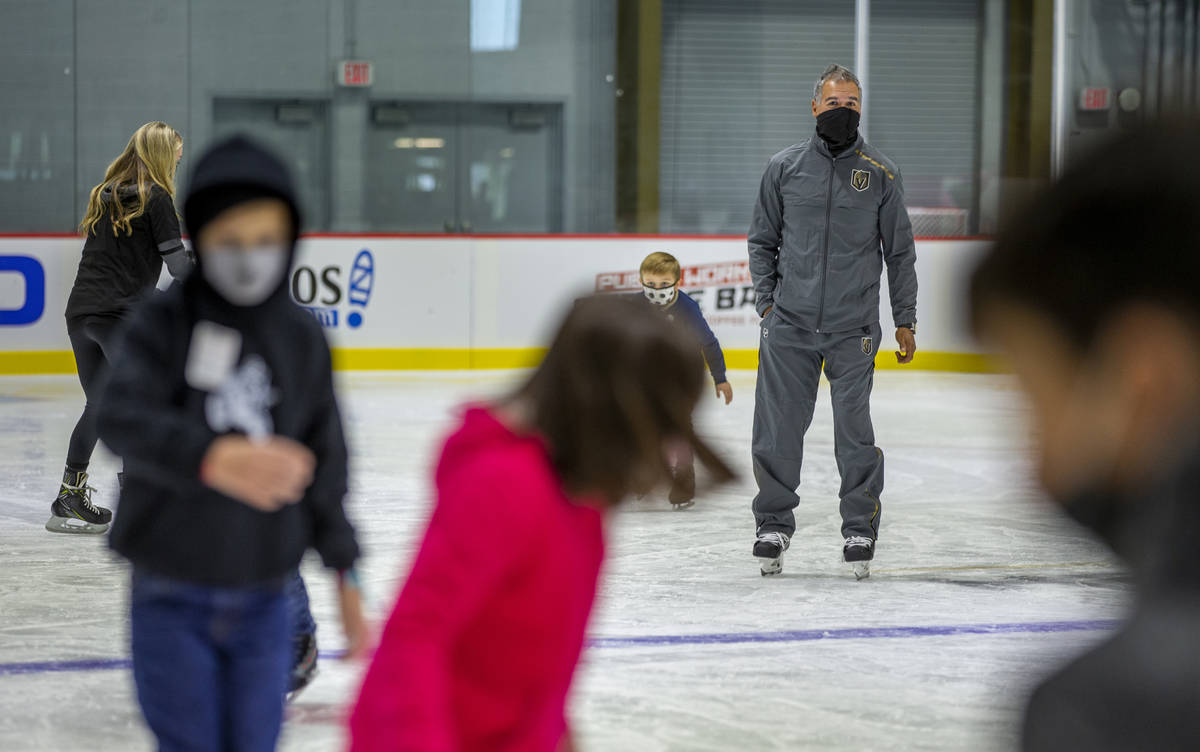 Henderson Silver Knights head coach Emanuel Viveiros, right, skates amongst youngsters with the ...