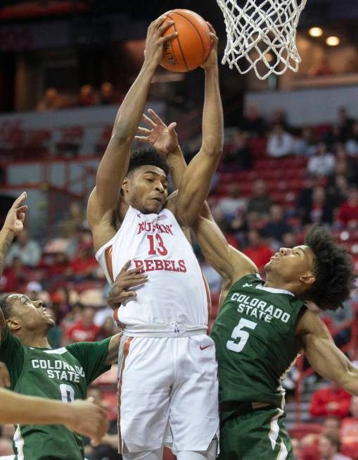 UNLV Rebels guard Bryce Hamilton (13) grabs a rebound over Colorado State Rams guard P.J. Byrd ...