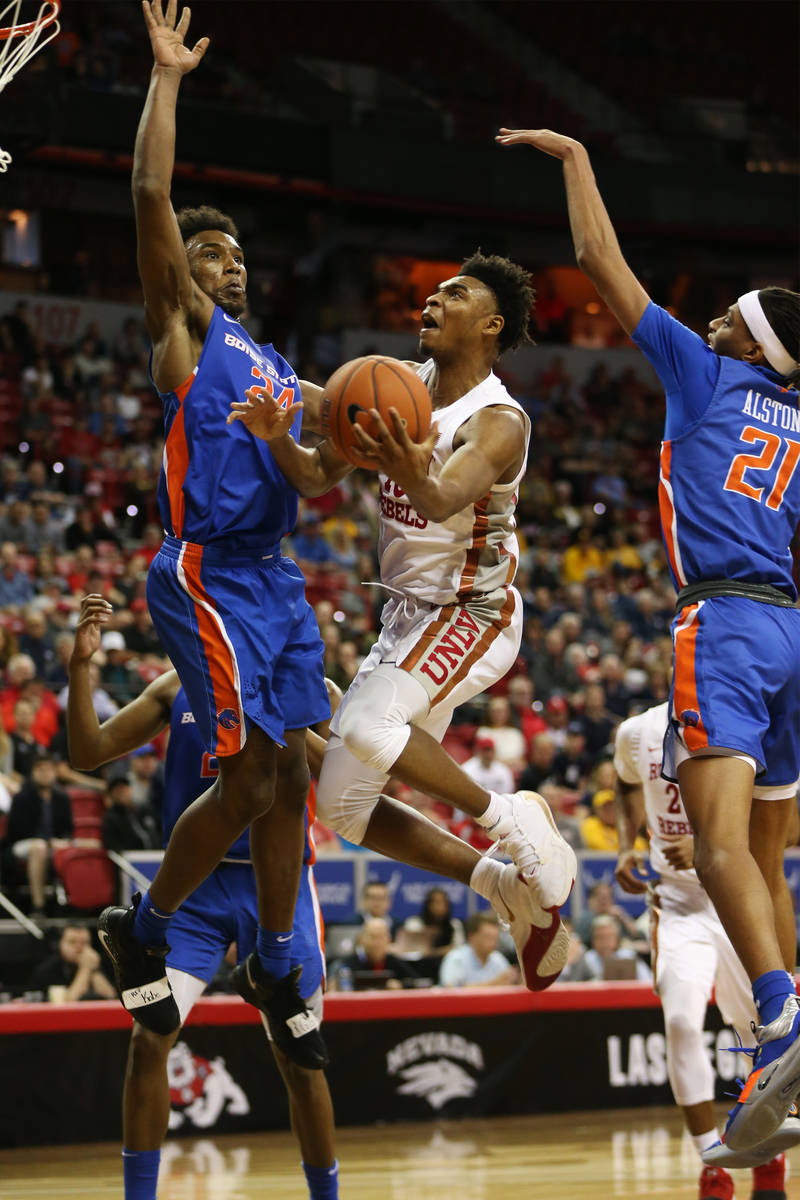 UNLV Rebels guard Bryce Hamilton (13) goes up for a shot against pressure from Boise State Bron ...