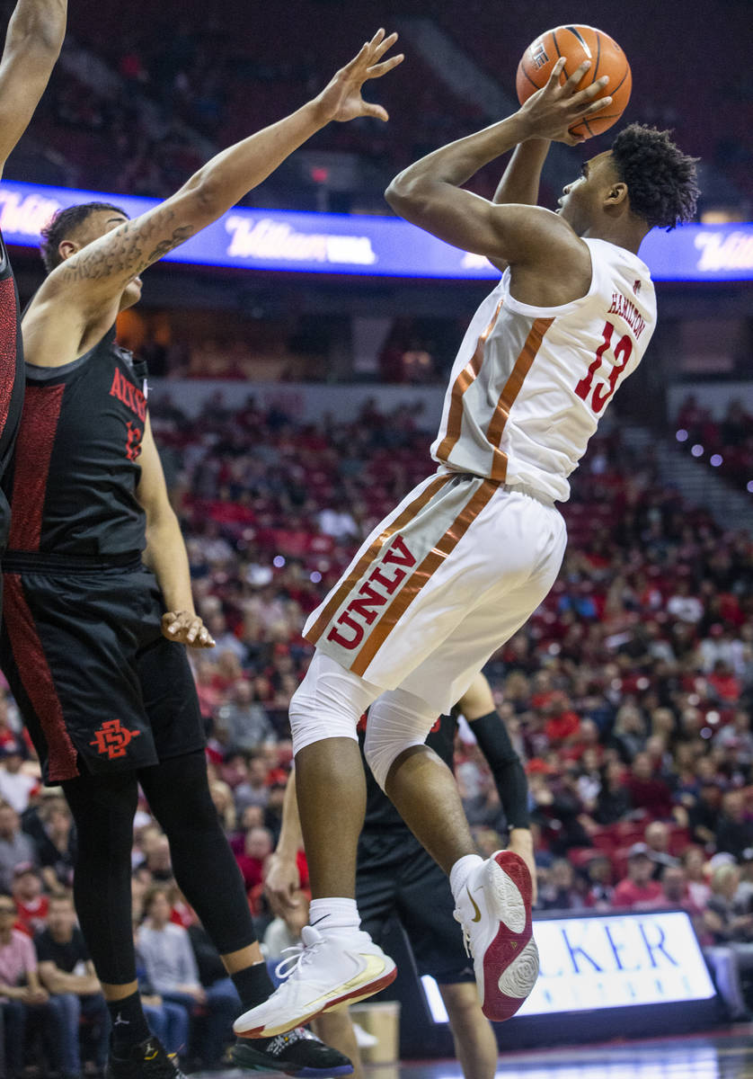 UNLV Rebels guard Bryce Hamilton (13, right) looks to take a shot over San Diego State Aztecs f ...