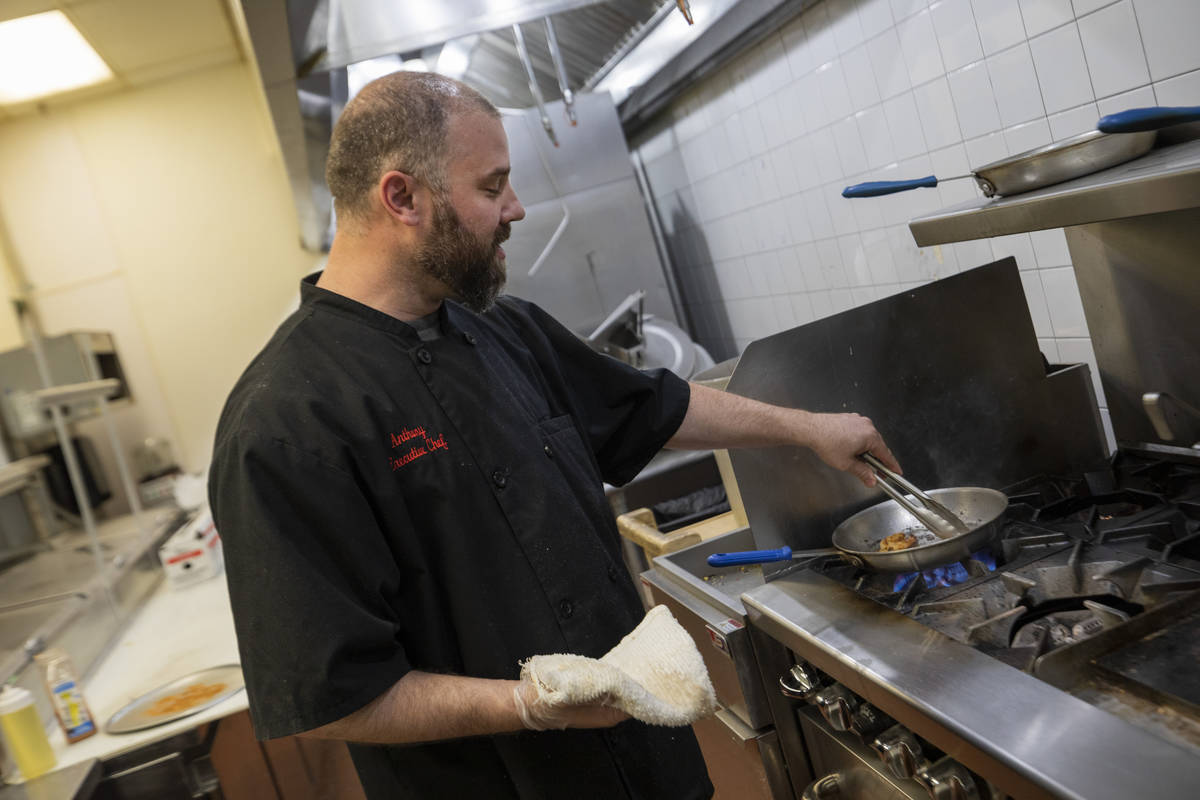 Executive Chef Anthony Santori sauts shrimp for shrimp and grits at the newly renovated concept ...