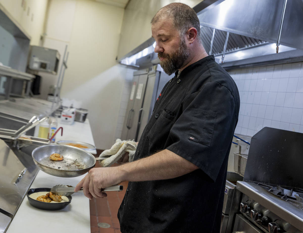 Executive Chef Anthony Santori plates shrimp and grits at the newly renovated concept bar Gambi ...