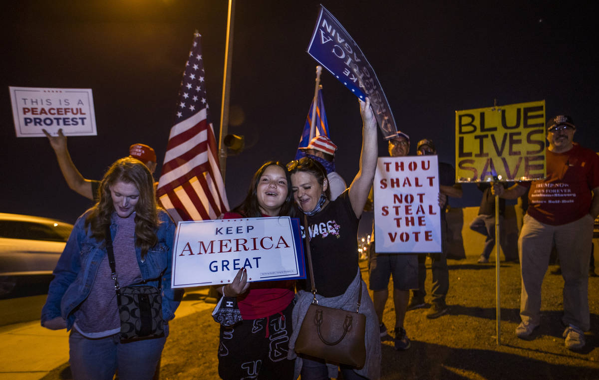 Lola and Beth Luciano pray with others as protests continue outside the Clark County Election D ...
