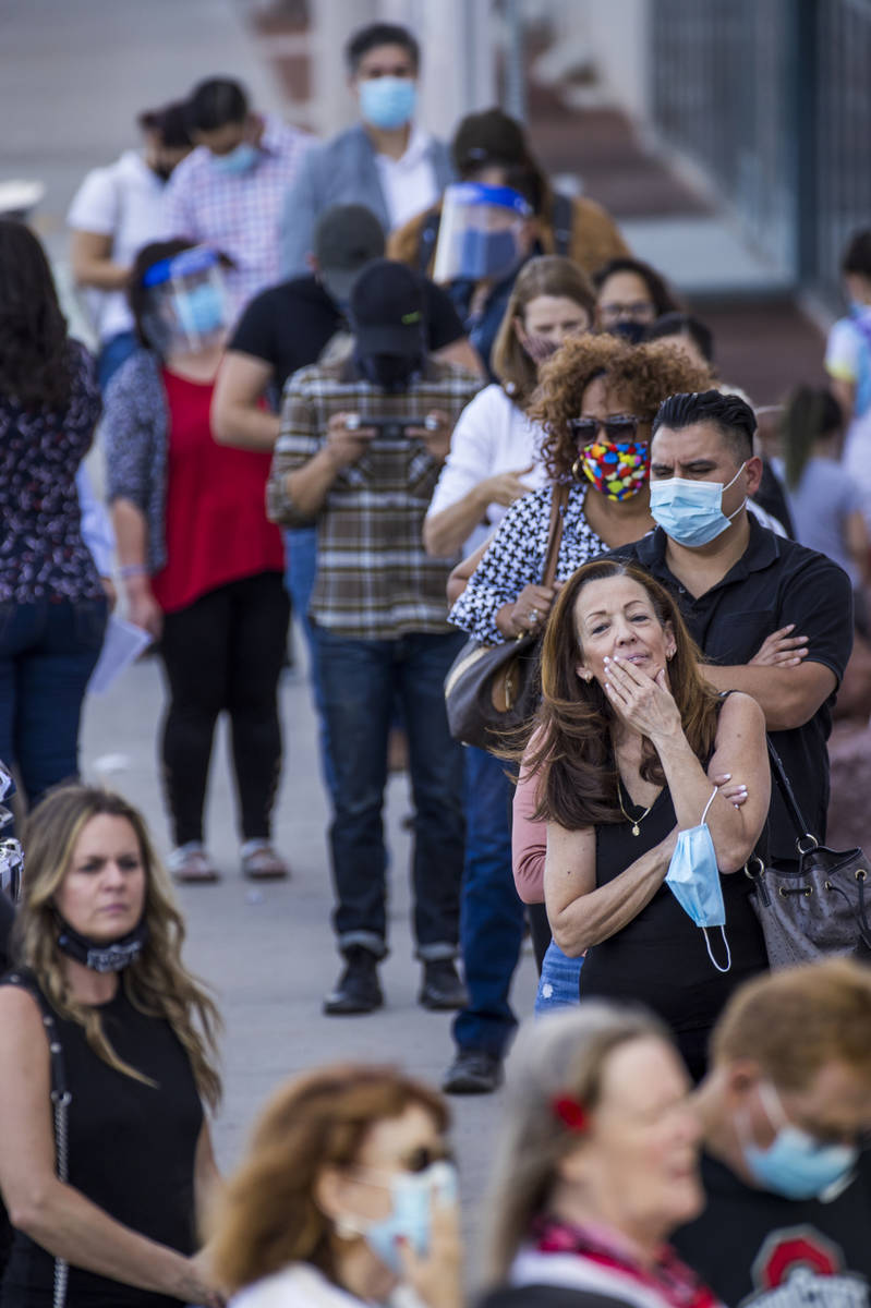 Voter Deborah Dunn of Las Vegas, right, awaits in line with others to cure their votes due to v ...