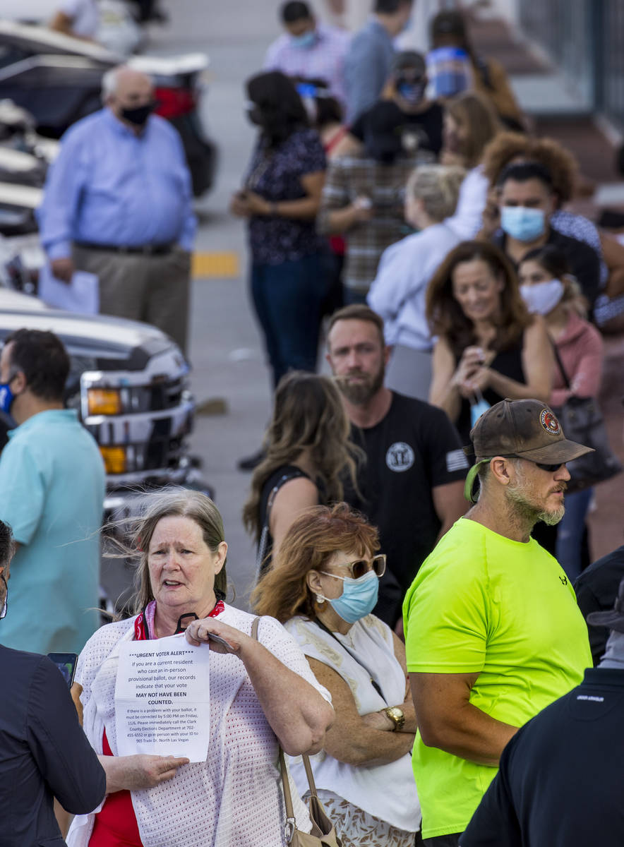 Voter Karen Zamrok of Las Vegas shows the letter she received to cure her vote as she awaits in ...