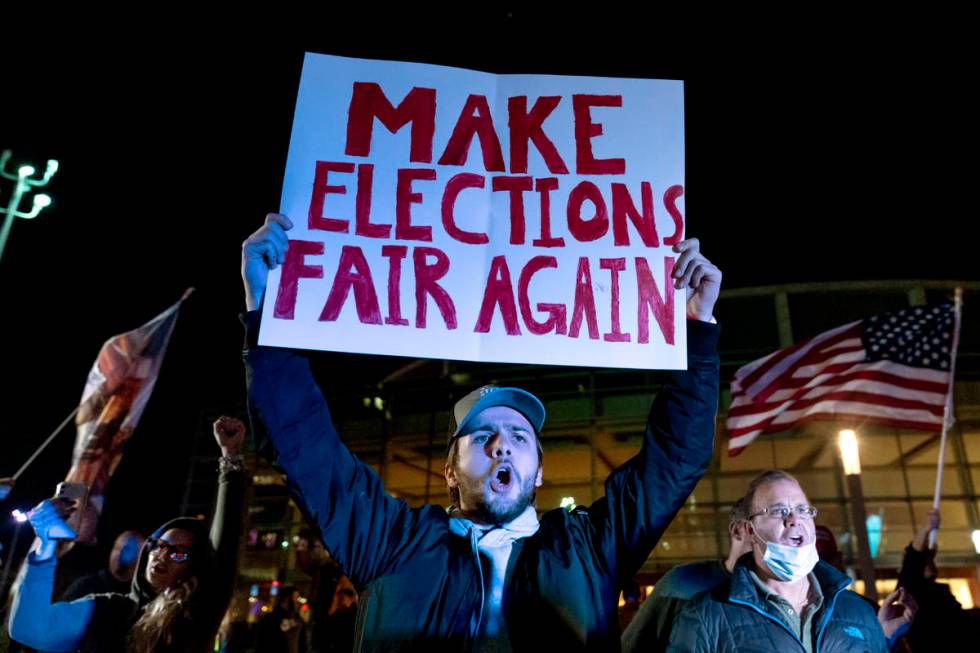 Trump supporter Jake Contos chants during a protest against the election results outside the ce ...