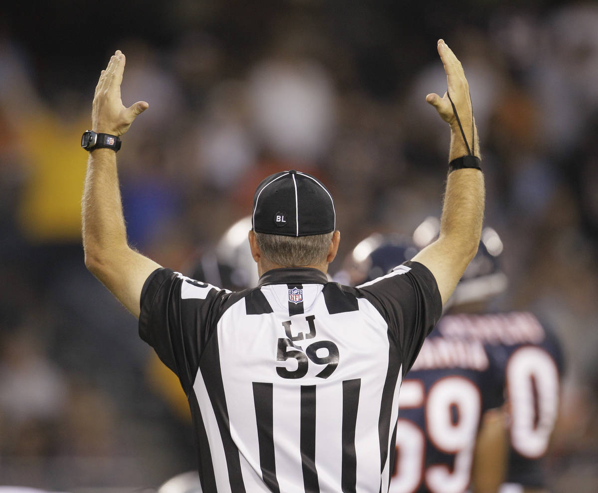 Line judge Rusty Baynes signals touchdown between the Chicago Bears and Oakland Raiders in a pr ...