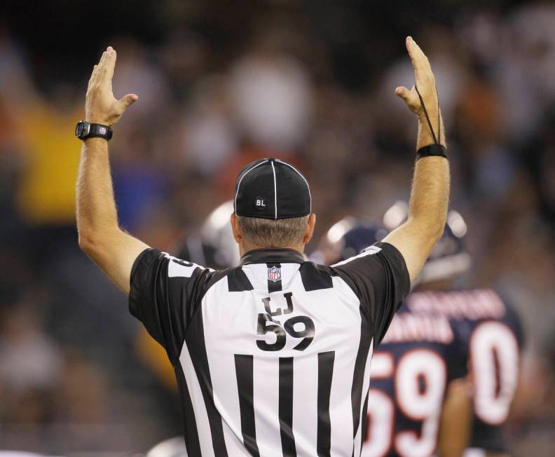 Line judge Rusty Baynes signals touchdown between the Chicago Bears and Oakland Raiders in a pr ...