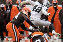 Las Vegas Raiders inside linebacker Cory Littleton (42) leaps over Cleveland Browns quarterback ...