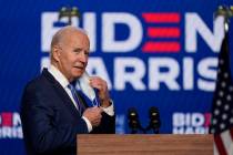 Democratic presidential candidate former Vice President Joe Biden removes his face mask as he a ...