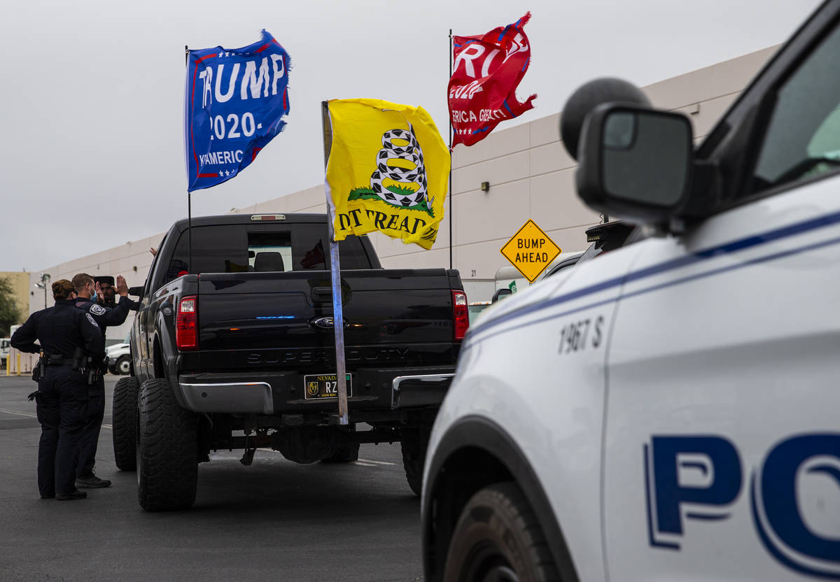 North Las Vegas police stop supporters of President Donald Trump in the parking lot of the Clar ...