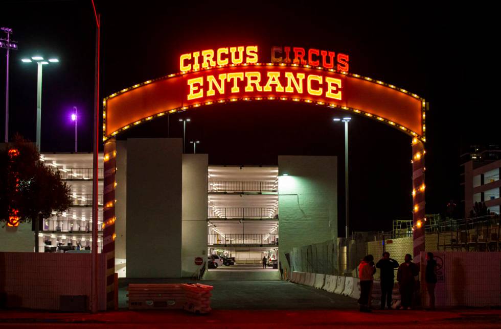 People stand outside of a parking lot entrance at Circus Circus where multiple people were shot ...