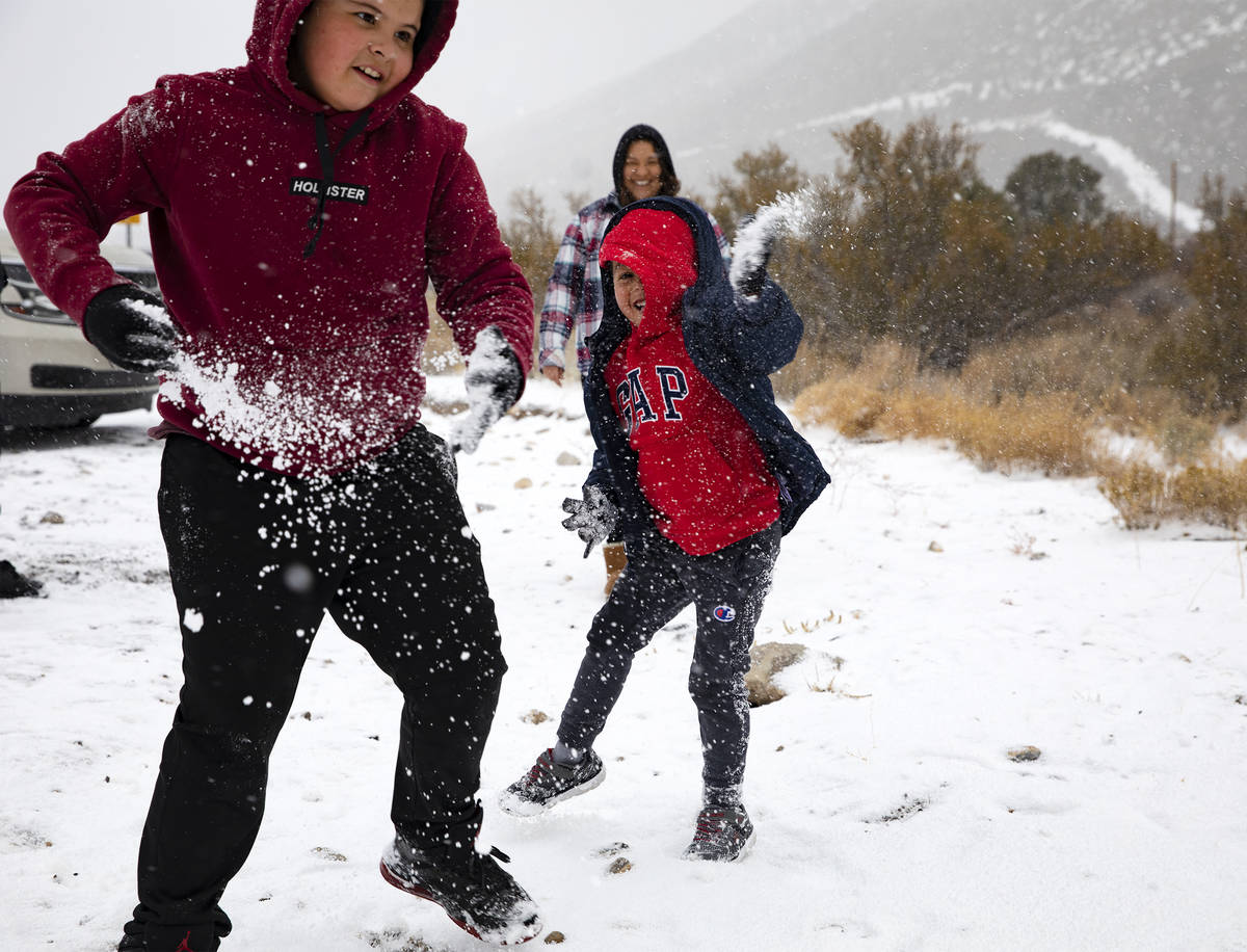 Joan Vasquez, 5, throws a snowball at his brother Max Vasquez, 10, as they play at Mt. Charlest ...