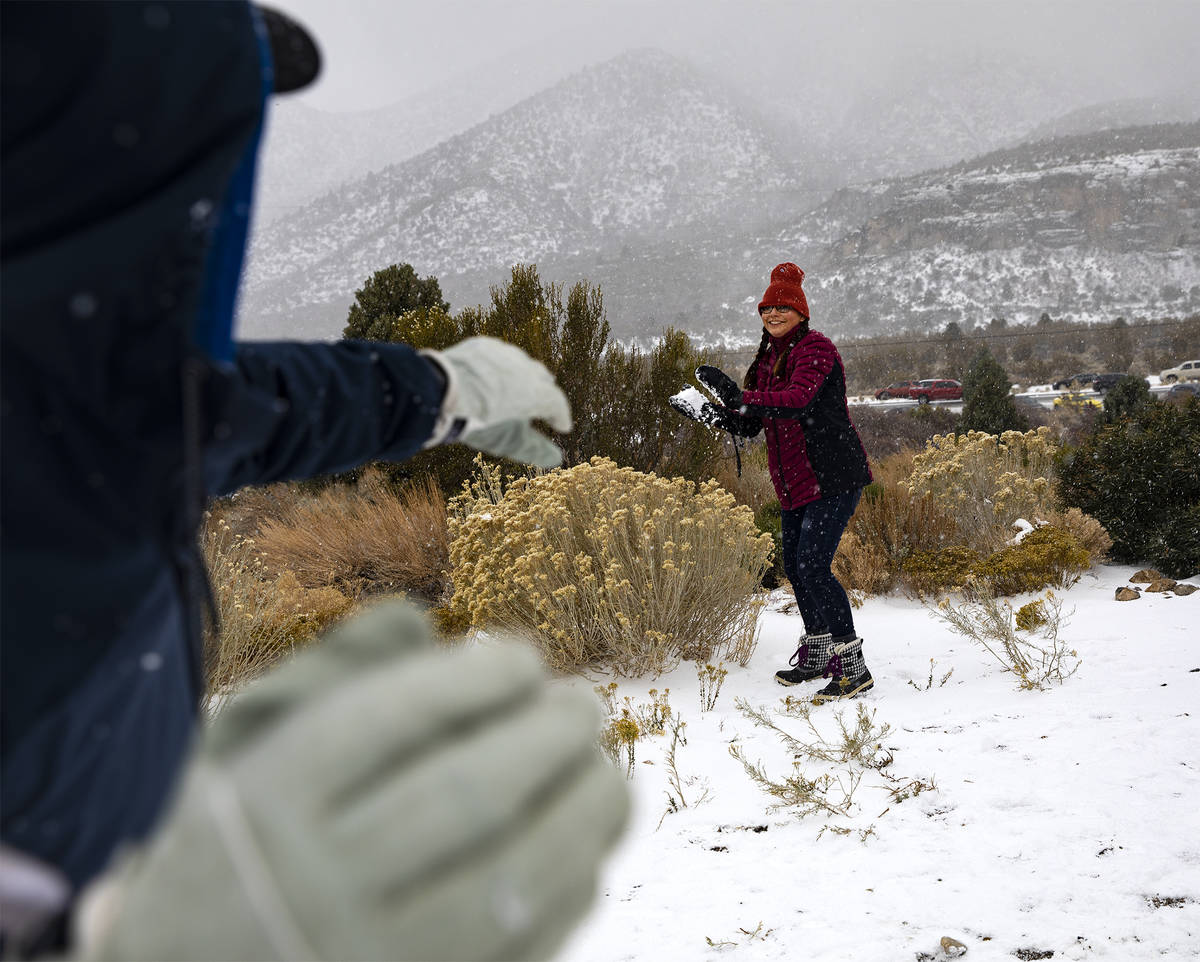 Jamie Byrd, center, prepares to throw a snowball at her husband Marshall Byrd, left, at Mt. Cha ...