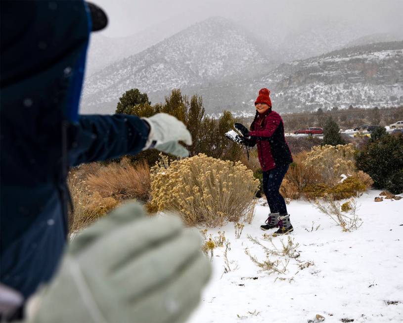 Jamie Byrd, center, prepares to throw a snowball at her husband Marshall Byrd, left, at Mt. Cha ...