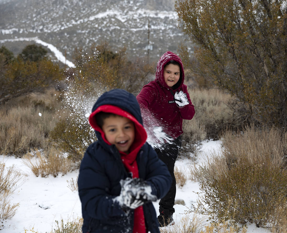 Max Vasquez, 10, throws a snowball at Joan Vasquez, 5, as they play at Mt. Charleston, Sunday, ...