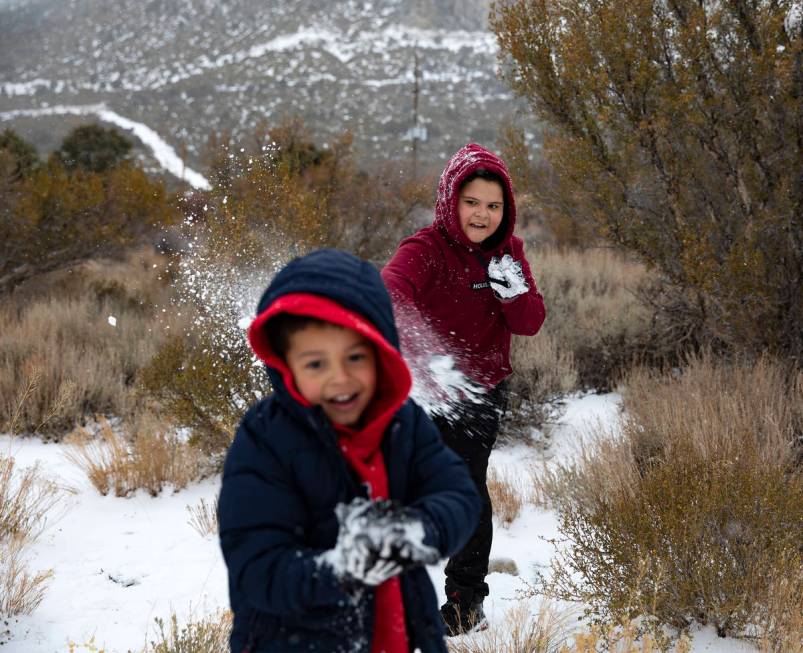 Max Vasquez, 10, throws a snowball at Joan Vasquez, 5, as they play at Mt. Charleston, Sunday, ...