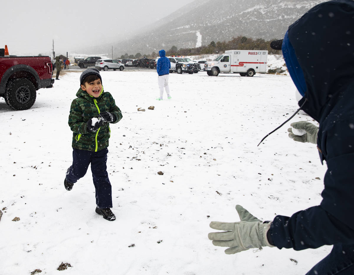 Marshall Byrd, 7, runs towards his dad Tyler Byrd with a snowball at Mt. Charleston on Sunday, ...