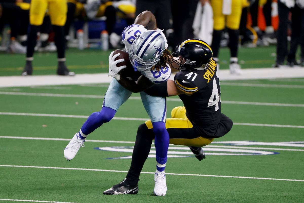 Dallas Cowboys wide receiver CeeDee Lamb (88) is stopped by Pittsburgh Steelers linebacker Robe ...