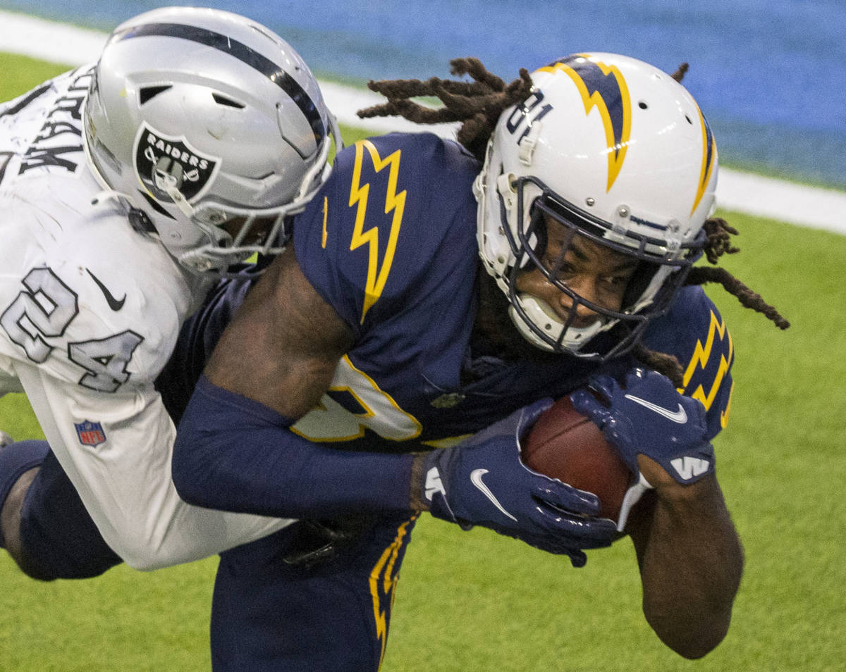 Los Angeles Chargers wide receiver Mike Williams (81) makes a catch over Las Vegas Raiders stro ...