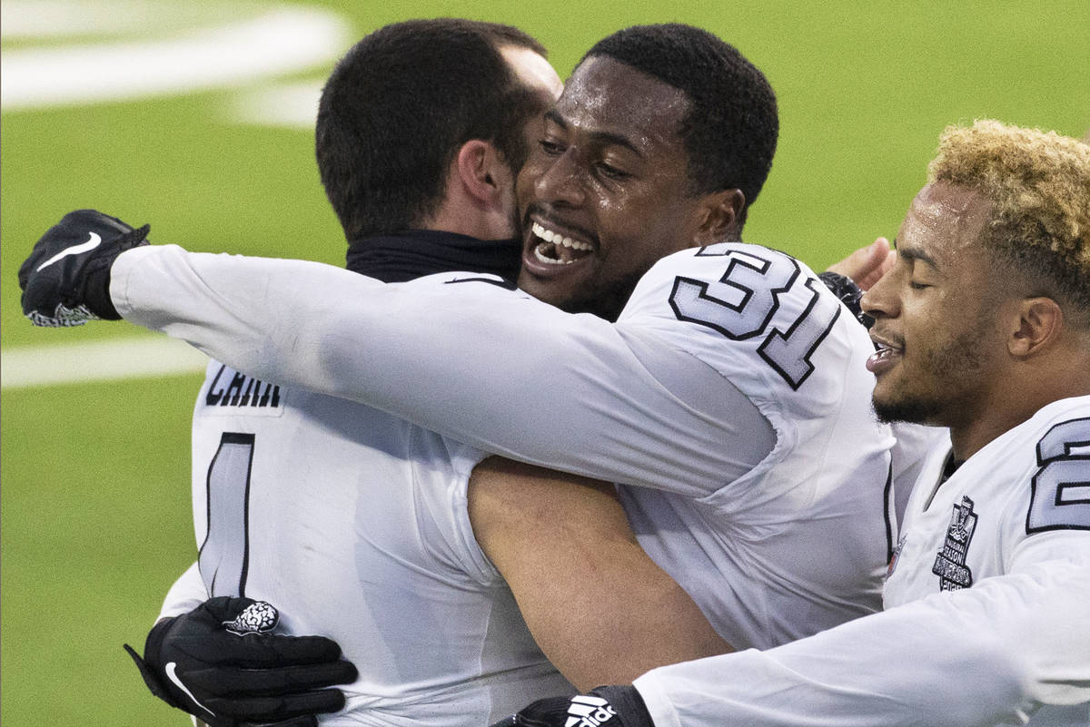 Las Vegas Raiders cornerback Isaiah Johnson (31) gets a hug from Las Vegas Raiders quarterback ...