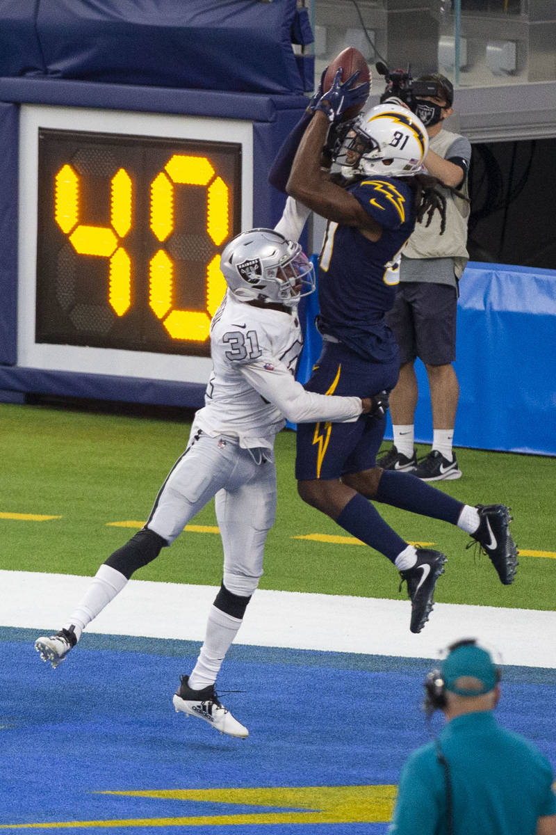Las Vegas Raiders cornerback Isaiah Johnson (31) defends in the end zone as Los Angeles Charger ...