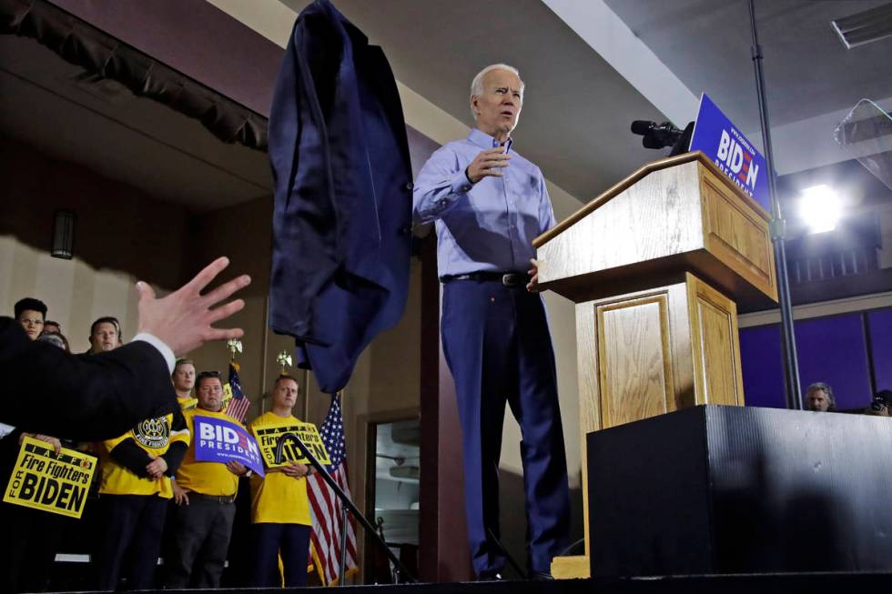 Former Vice President and Democratic presidential candidate Joe Biden tosses his jacket off sta ...